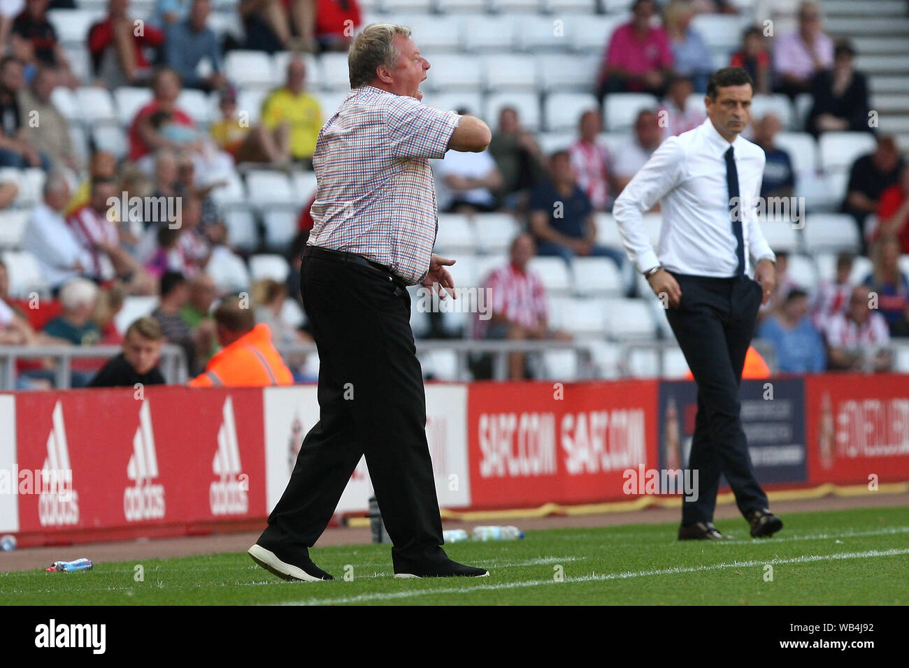 Sunderland, UK. 24th Aug, 2019.AFC Wimbledon manager Wally Downes (left) during the Sky Bet League 1 match between Sunderland and AFC Wimbledon at the Stadium Of Light, Sunderland on Saturday 24th August 2019. (Credit: Steven Hadlow | MI News) Editorial use only, license required for commercial use. No use in betting, games or a single club/league/player publications. Photograph may only be used for newspaper and/or magazine editorial purposes Credit: MI News & Sport /Alamy Live News Stock Photo