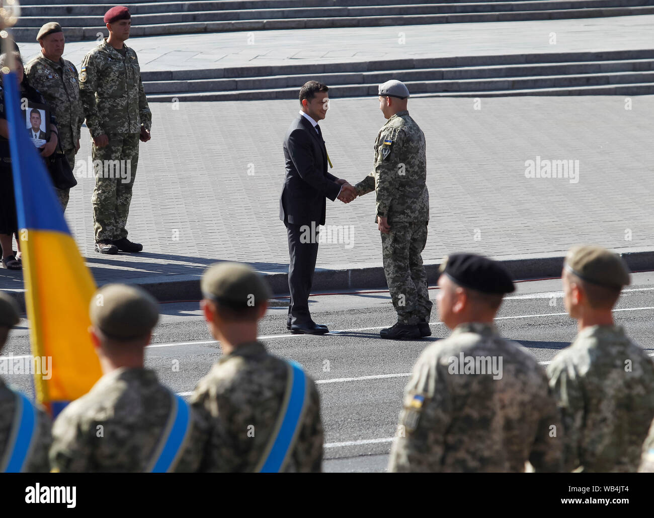 Ukrainian President Volodymyr Zelensky (C) hands over a state award to the Ukrainian servicemen during the 28th anniversary of Independence Day at the Independence Square in Kiev.Ukrainians mark the 28th anniversary of Ukraine's independence from the Soviet Union since 1991. Stock Photo