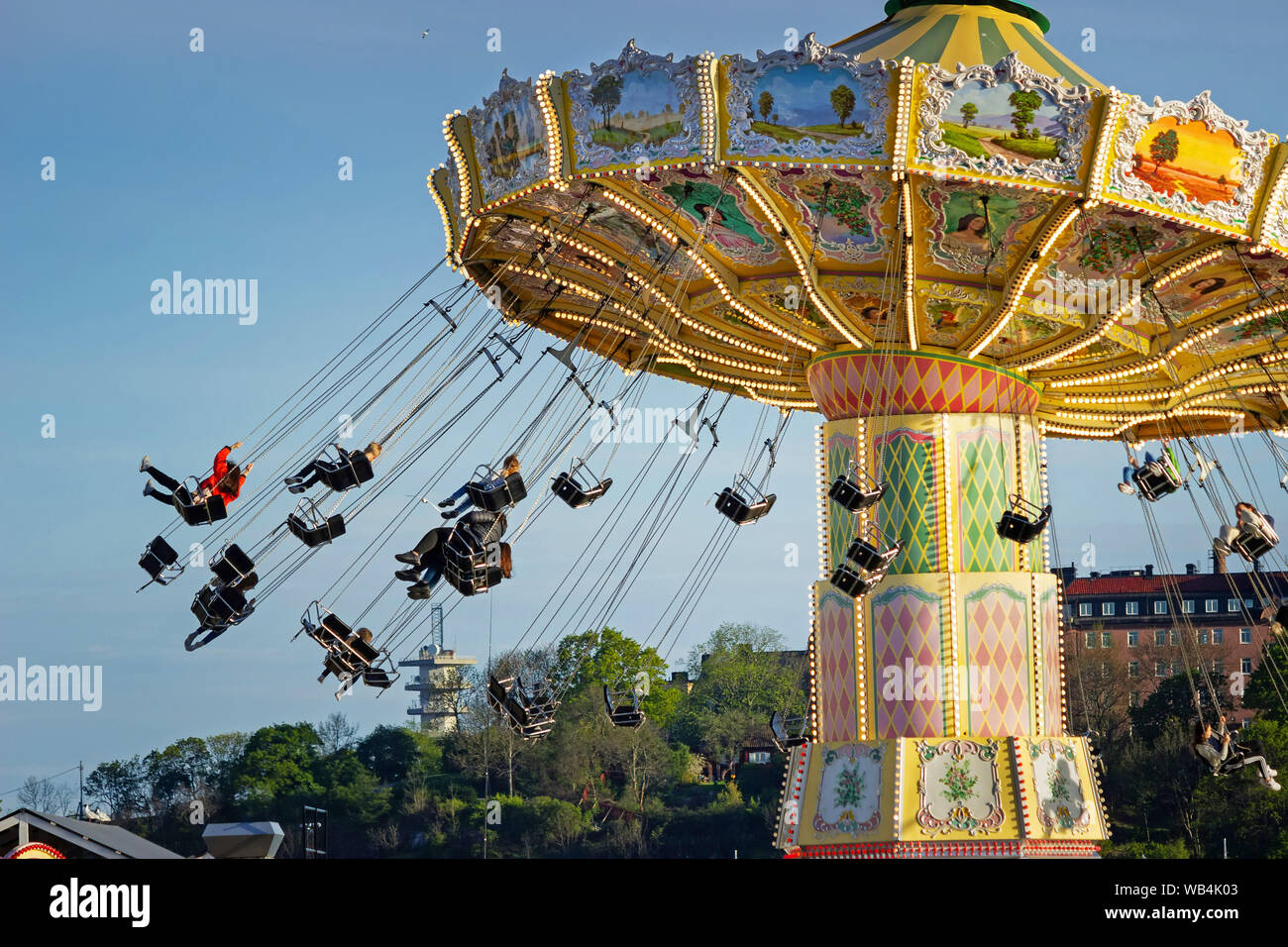 People spinning in Eclipse (Ferris wheel) attraction at the Tivoli Grona Lund amusement park, Djurgarden, Stockholm Sweden Stock Photo
