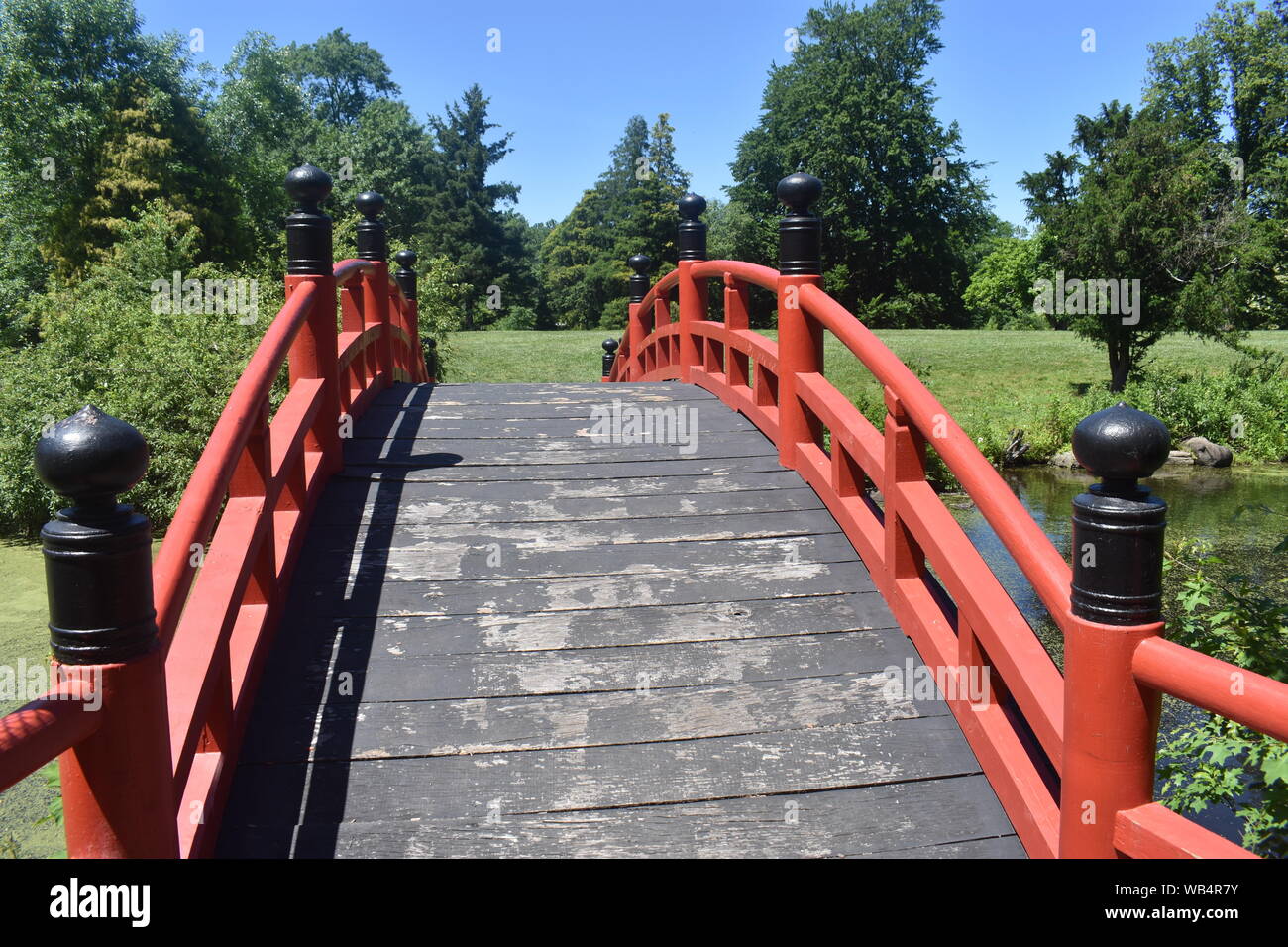 Red wooden bridge in a Japanese meditation garden at Duke Farms, Hillsborough, New Jersey -04 Stock Photo