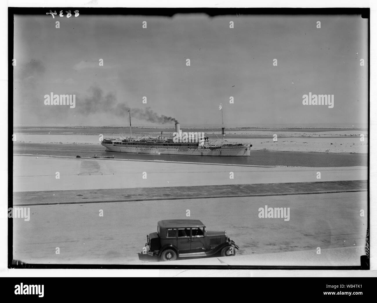 Egypt. Ismailia. Ship passing through the canal. Taken from monum[ent] terrace, closer Abstract/medium: G. Eric and Edith Matson Photograph Collection Stock Photo