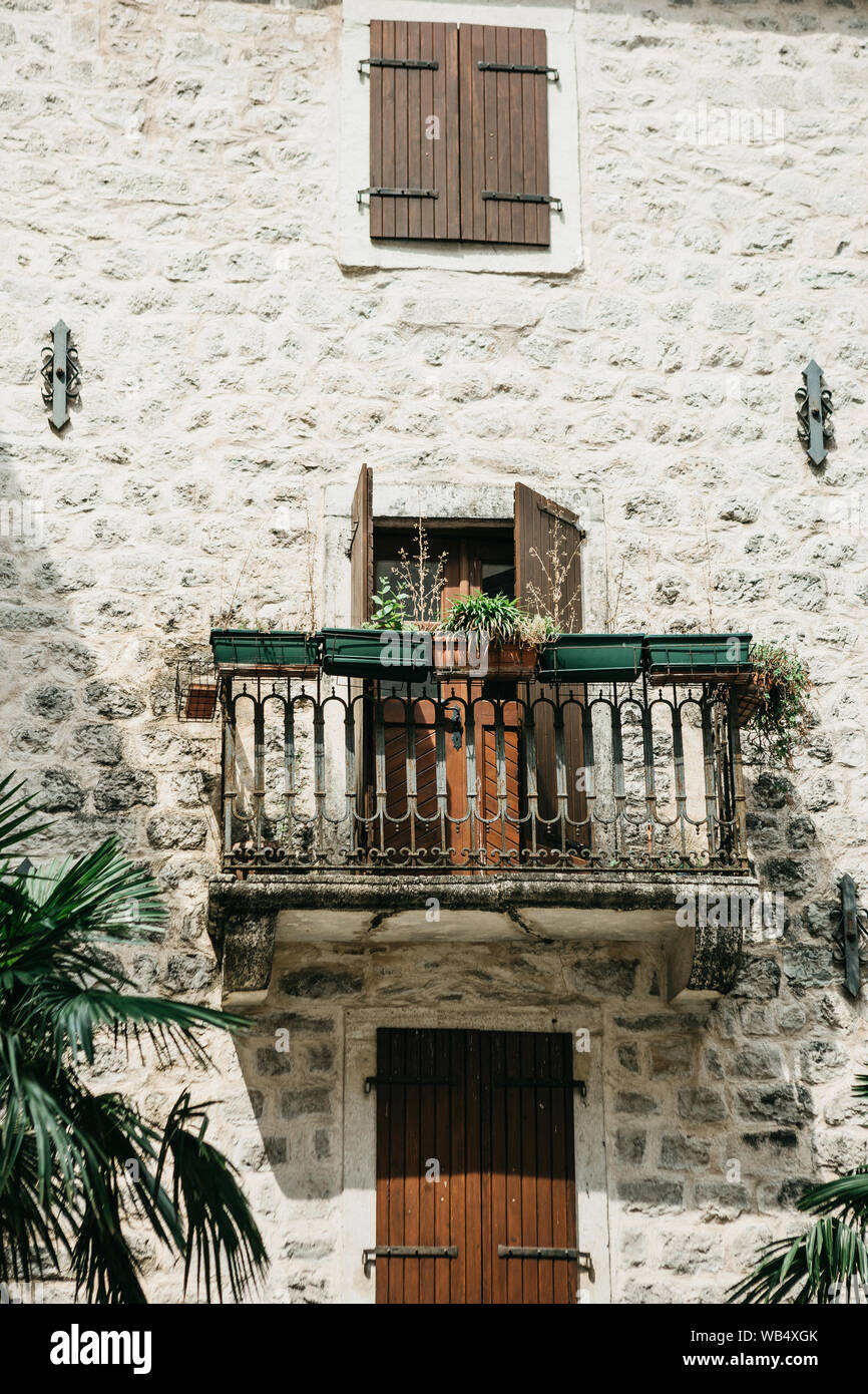 Close up view of a traditional old building with a balcony in Montenegro. Old house with a balcony Stock Photo