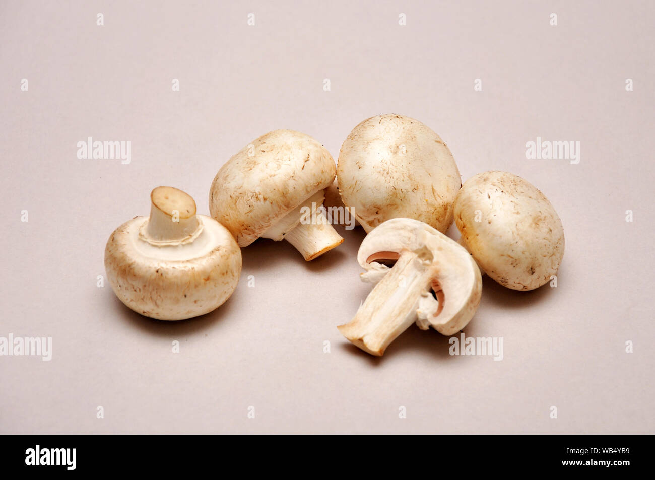 whole and sliced button mushrooms on a seamless background Stock Photo