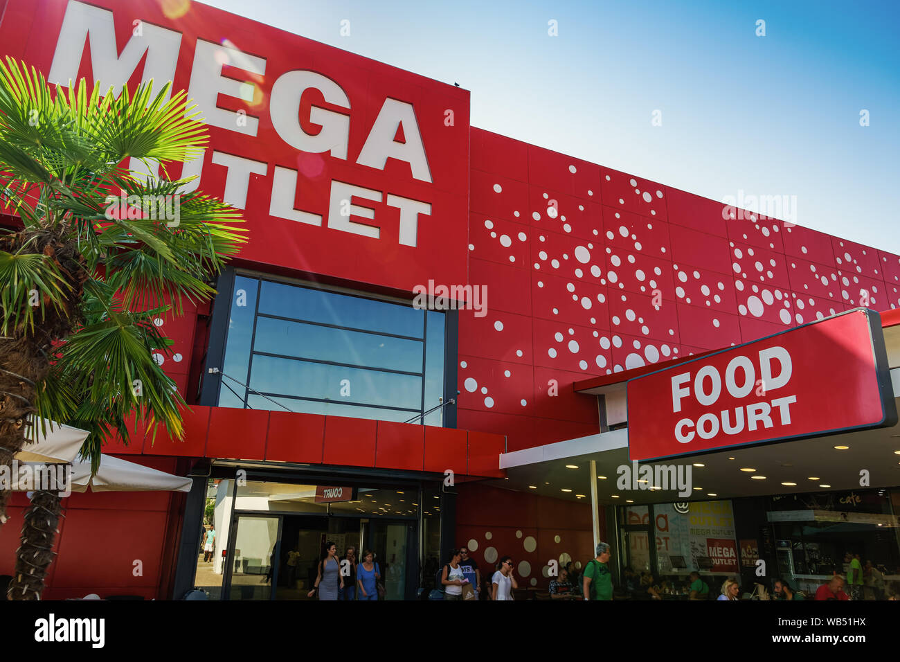 Thessaloniki, Greece MEGA Outlet shopping mall facade. Discount shopping center entrance in Northern Greece with crowd at entrance next to food court. Stock Photo