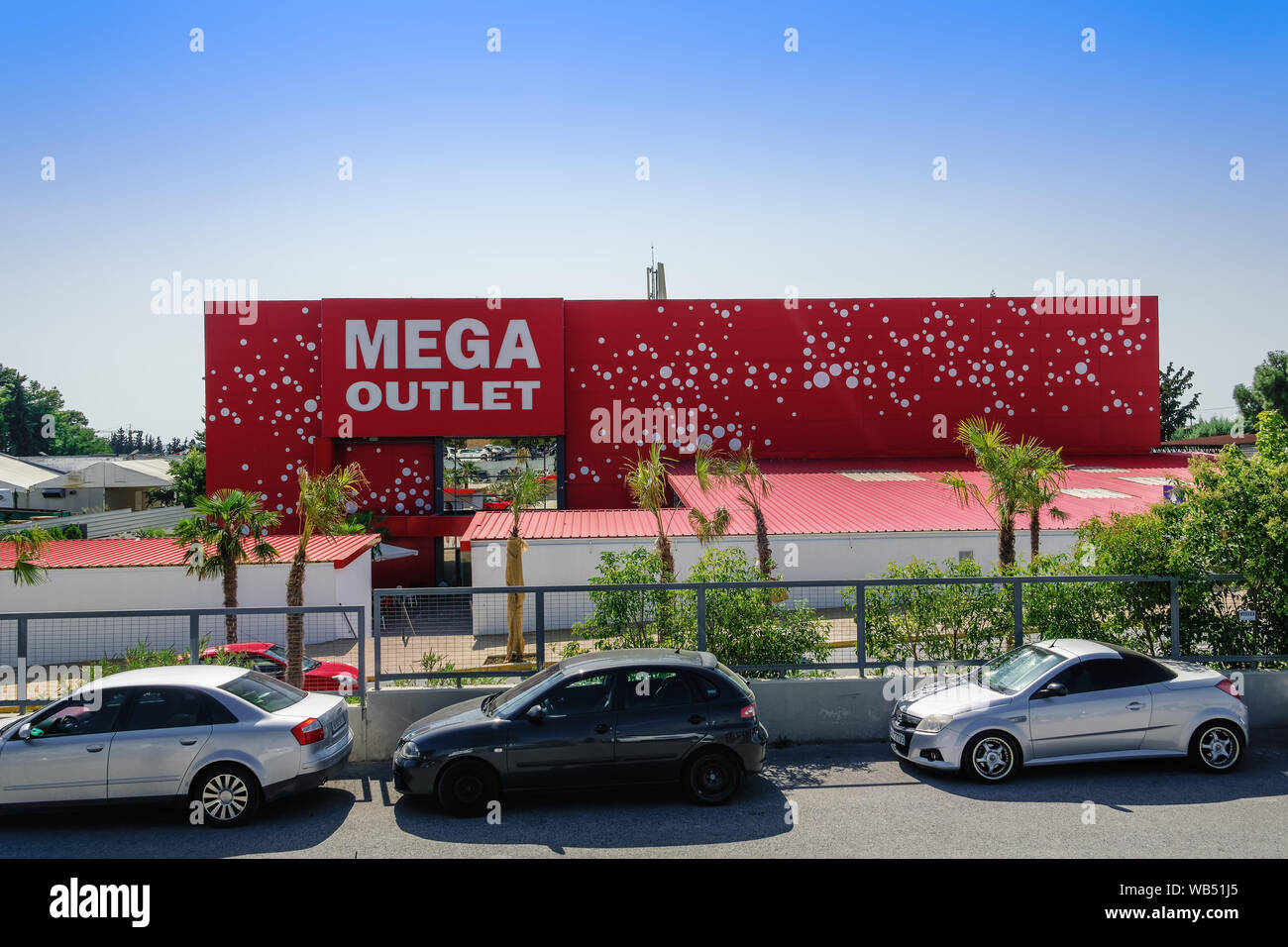 Thessaloniki Greece MEGA Outlet shopping mall facade. Discount shopping  center entrance in Northern Greece, at Pylaia area, with red & white logo  art Stock Photo - Alamy