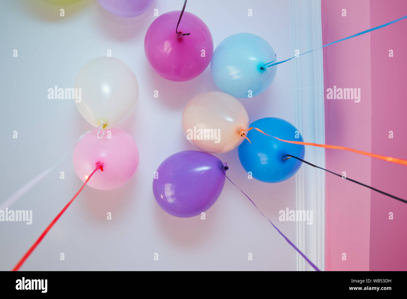 Helium balloons . Colorfull balloons float on the white ceiling in the
