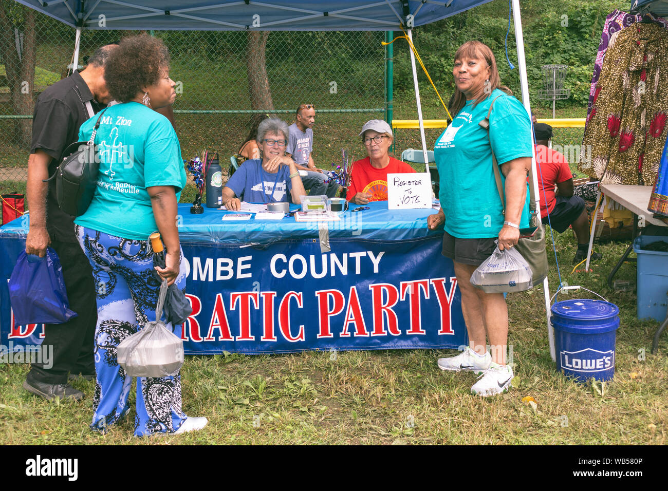 Democrat volunteers talk with festival goers, registering voters, at the East End/Valley Street Community Heritage Festival in Asheville, NC, USA Stock Photo