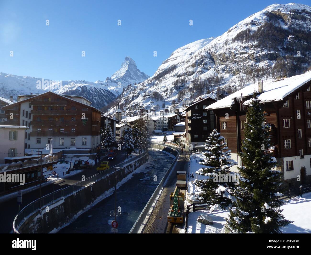 The frosty river and snow topped Swiss chalets in the centre of Zermatt