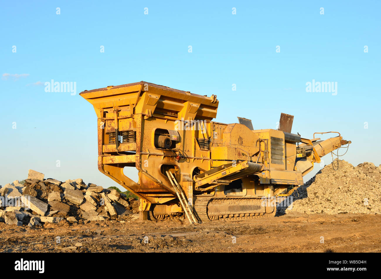 https://c8.alamy.com/comp/WB5D4H/mobile-stone-crusher-machine-by-the-construction-site-or-mining-quarry-for-crushing-old-concrete-slabs-into-gravel-and-subsequent-cement-production-WB5D4H.jpg