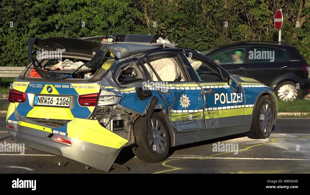 Wesseling, Germany. 24th Aug, 2019. A police car is badly damaged after an accident. During an emergency drive, an officer in the Rhine-Erft district had an accident with his vehicle and was seriously injured. On the state road 192 he bumped into another car on Saturday afternoon and overturned several times. His car then collided with an oncoming vehicle and was catapulted over it before touching another car. Four other people were slightly injured in the accident. Credit: Thomas Kraus/dpa/Alamy Live News Stock Photo