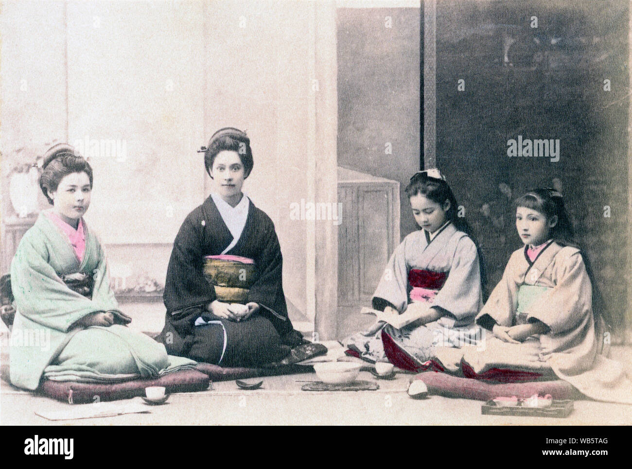 [ 1890s Japan - Westerners in Kimono ] —   A Western family in Japanese costumes. It was very common in the late nineteenth century for Westerners to have themselves photographed wearing Japanese clothing.   Albumen photograph sourced by Kozaburo Tamamura (1856-1923?), 1890s, for 'Japan, Described and Illustrated by the Japanese', Shogun Edition edited by Captain F Brinkley. Published in 1897 by J B Millet Company, Boston Massachusetts, USA.  19th century vintage albumen photograph. Stock Photo