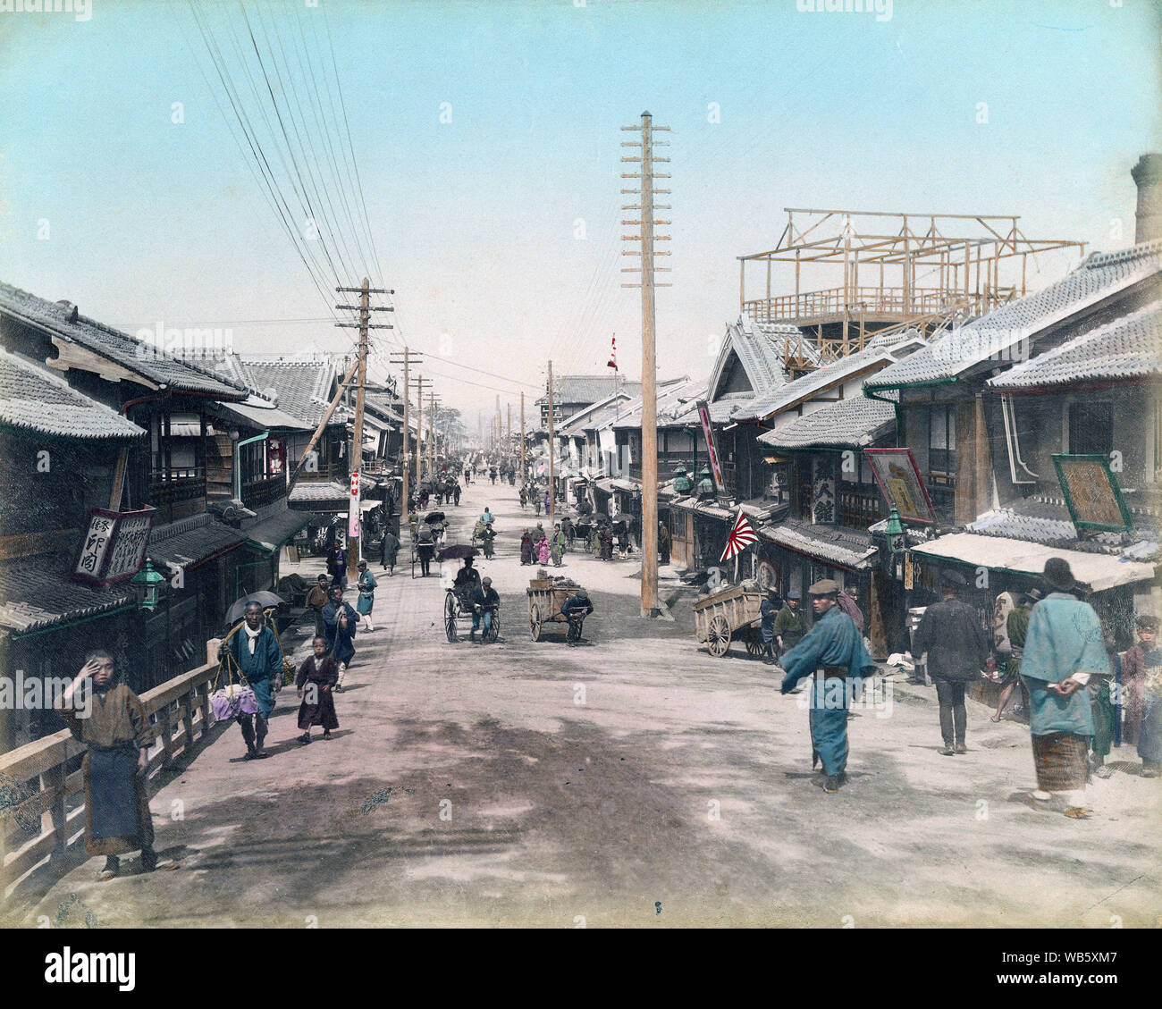 [ 1890s Japan - Japanese Street View in Kobe ] —   Tamon-dori in Kobe, Hyogo Prefecture as seen from Minatogawa River sometime in the 1890s. The pine trees on the far left locate Minatogawa Jinja.  19th century vintage albumen photograph. Stock Photo