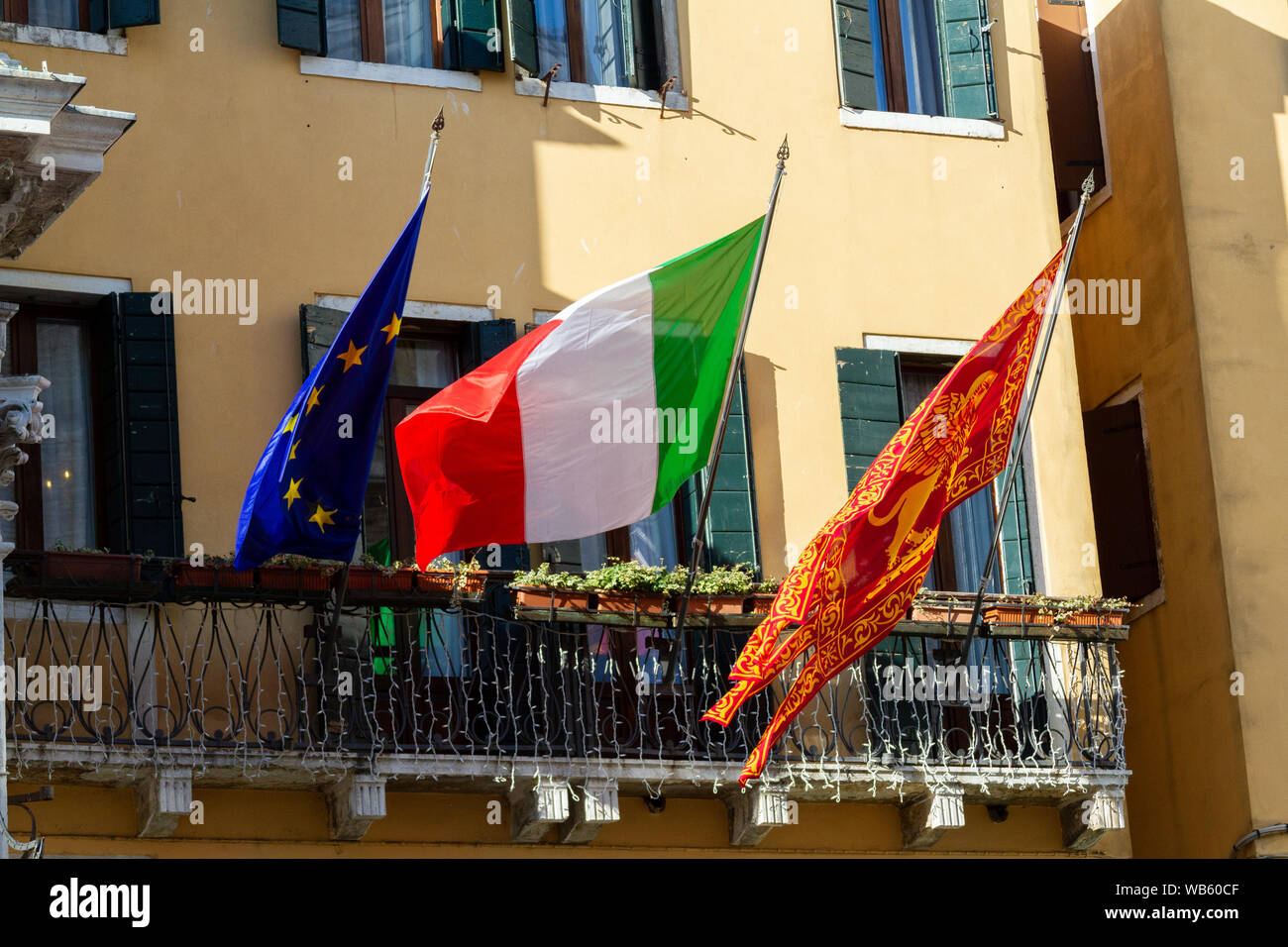Italian, European Union's and Venice's flags hung together. Stock Photo