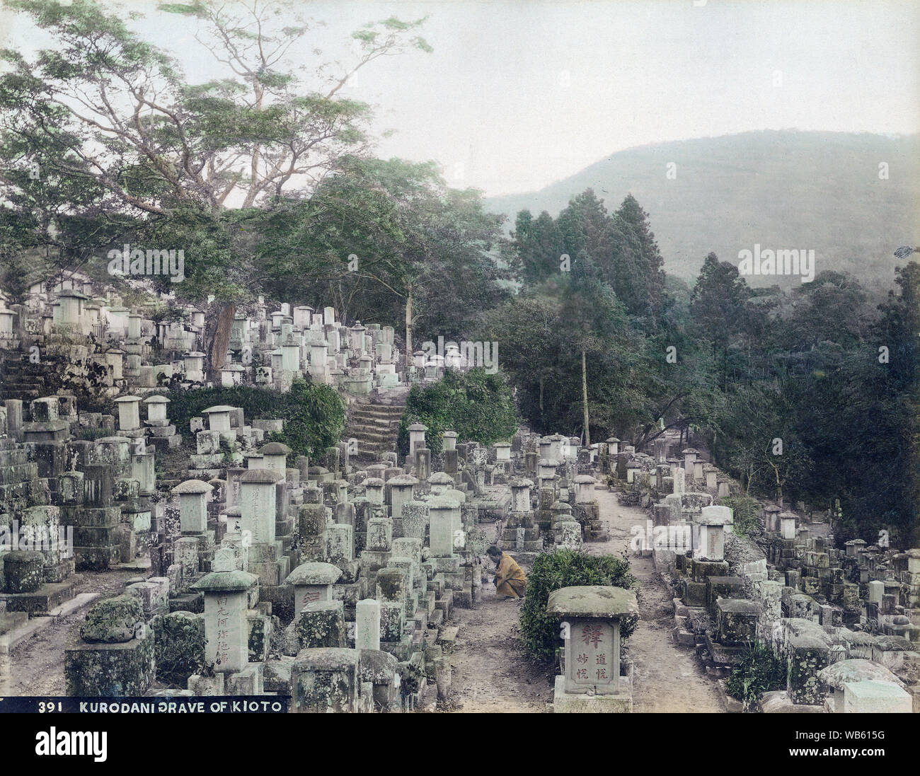 [ 1890s Japan - Japanese Buddhist Graveyard in Kyoto ] —   A man prays at the graveyard of Kurodani buddhist temple in Kyoto.  19th century vintage albumen photograph. Stock Photo