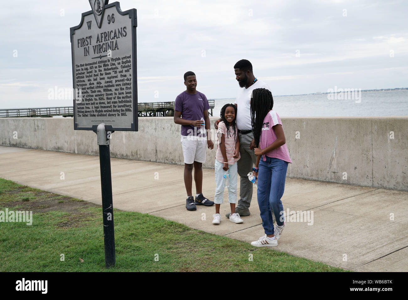 Hampton, USA. 24th Aug, 2019. People watch the First Africans in Virginia sign at Fort Monroe in Hampton, Virginia, on Aug. 24, 2019. Activities are held from Aug. 23 to 25 in commemoration of the 400th anniversary of the first African landing which occurred at Old Point Comfort in Virginia in 1619. Credit: Liu Jie/Xinhua/Alamy Live News Stock Photo