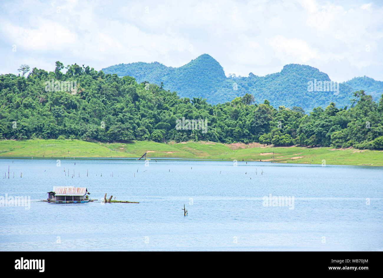 The wooden raft on the water in reservoirs and mountain views at Khao Laem National Park ,Kanchanaburi in Thailand. Stock Photo
