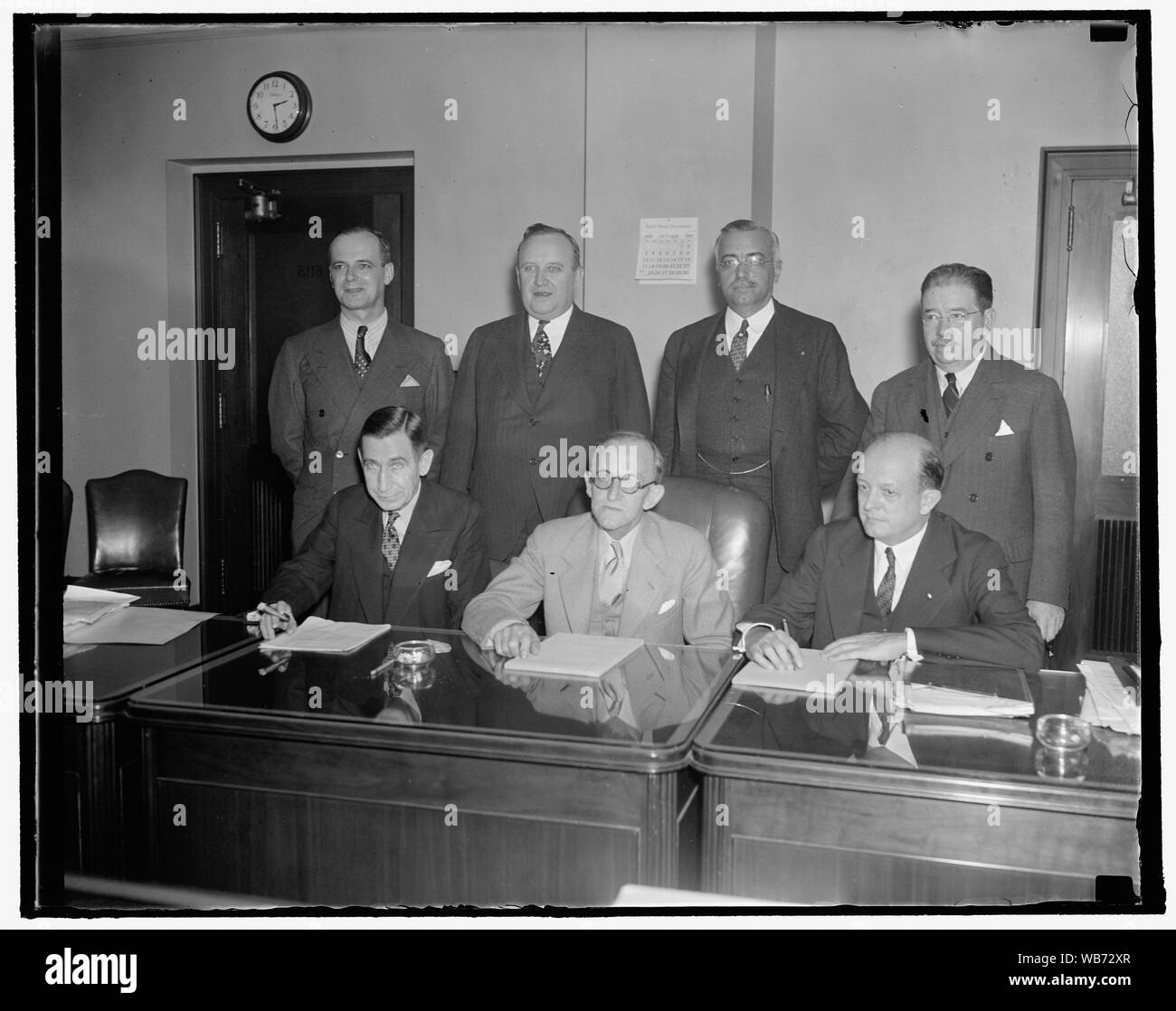 Federal Communications Commission. Washington, D.C., Oct. 6. A new picture of the Federal Comm. Commission, headed by the new Chairman Frank McNinch, formerly Chairman of the Federal Power Commission; left to right, seated: Eugene O. Sykes, Frank McNinch, Chairman Paul A. Walker, standing; left to right; T.A.M. Craven, Thad A. Brown, Norman S. Case, and George Henry Payne. 10/6/37 Abstract/medium: 1 negative : glass ; 4 x 5 in. or smaller Stock Photo