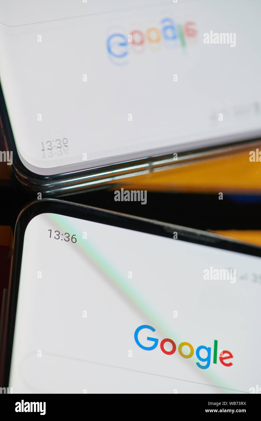 New york, USA - august 24, 2019: Using google browser  application on smartphone  macro close up  mirror view Stock Photo