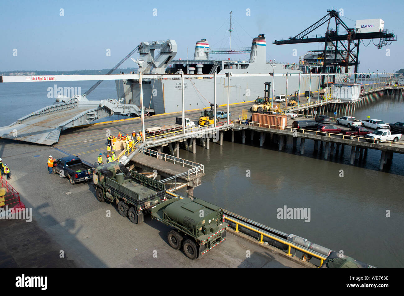 Longshoremen load military vehicles and equipment containers belonging to U.S. Army Alaska