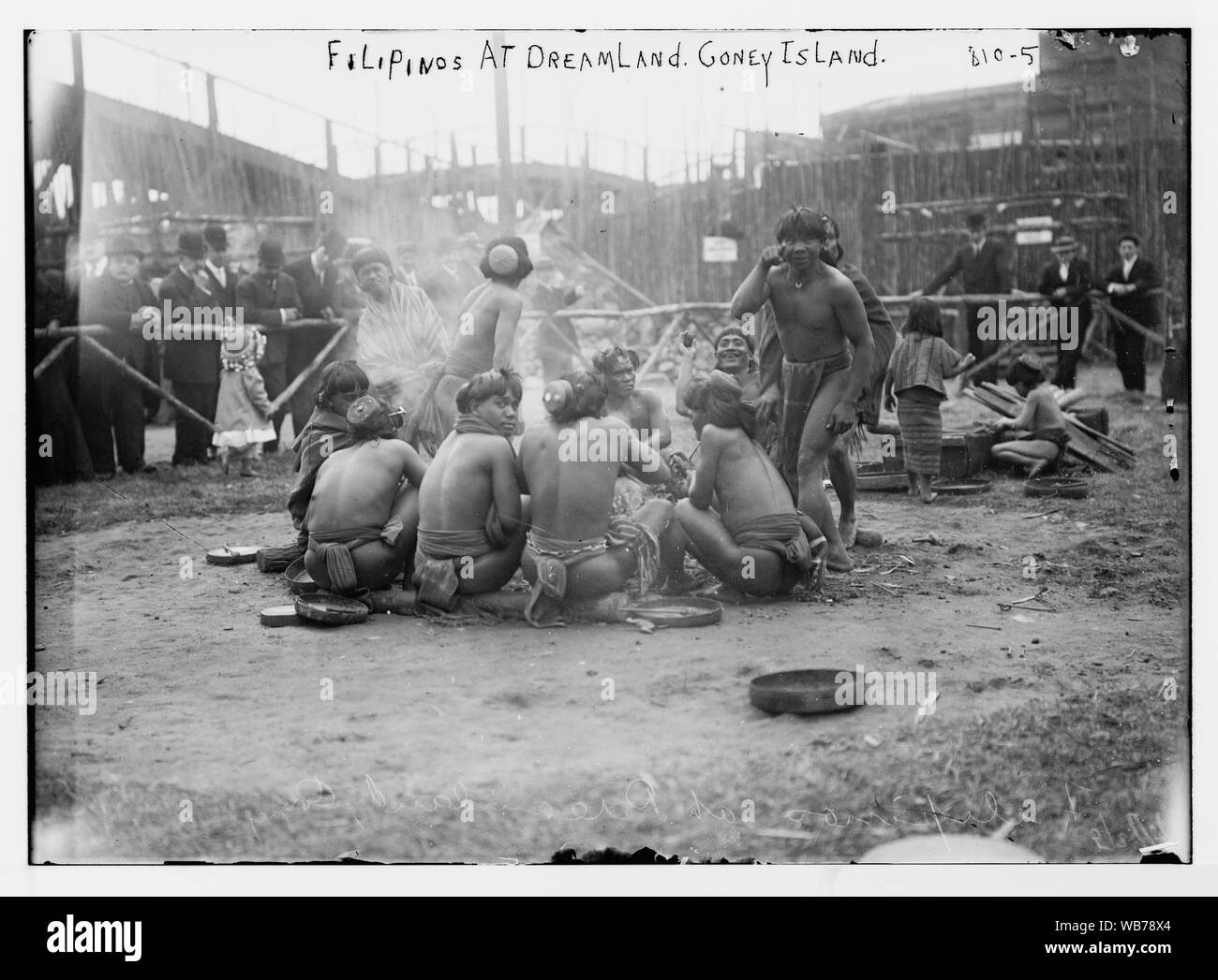 Filipinos in loin cloths sitting in circle together at Dreamland, Coney Island, N.Y. Abstract/medium: 1 negative : glass ; 5 x 7 in. or smaller. Stock Photo