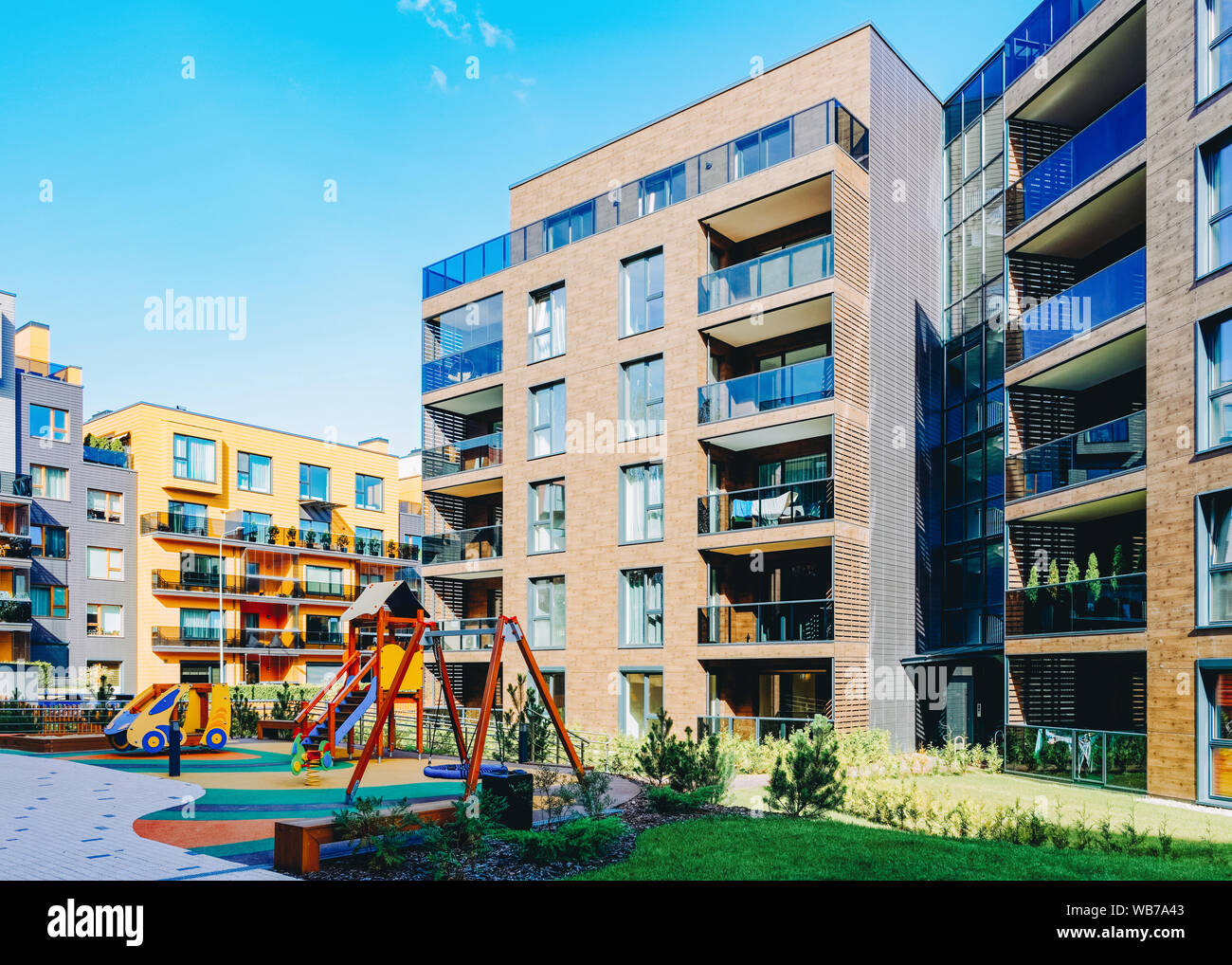 Children playground with European modern complex of apartment ...