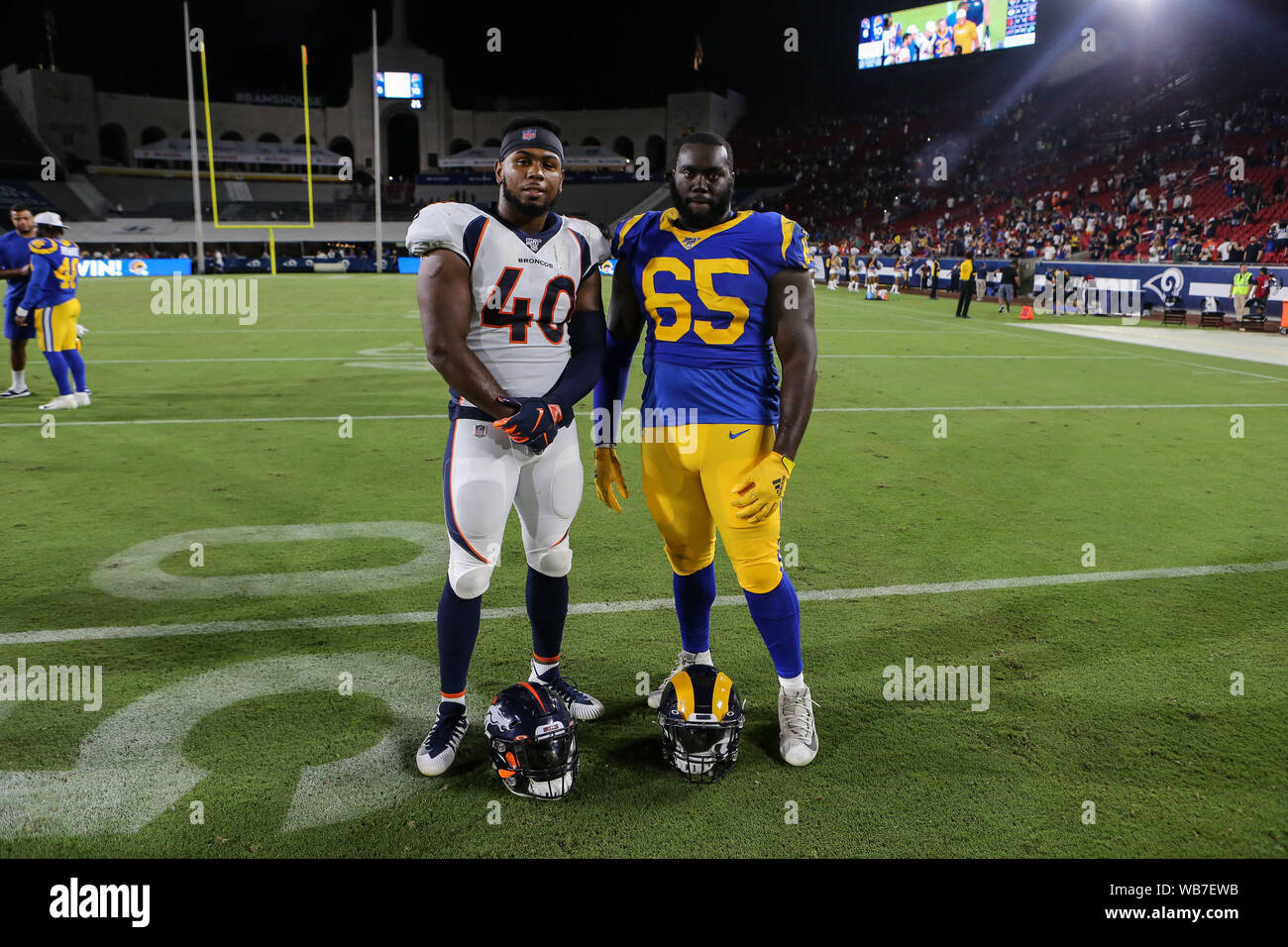 Los Angeles, CA., USA. 24th August, 2019. Narbonne High School graduates Denver Broncos linebacker Keishawn Bierria #40 and Los Angeles Rams defensive tackle Boogie Roberts #65 after the NFL game between Denver Broncos vs Los Angeles Rams at the Los Angeles Memorial Coliseum in Los Angeles, Ca on August 24, 2019. Jevone Moore Credit: Cal Sport Media/Alamy Live News Stock Photo