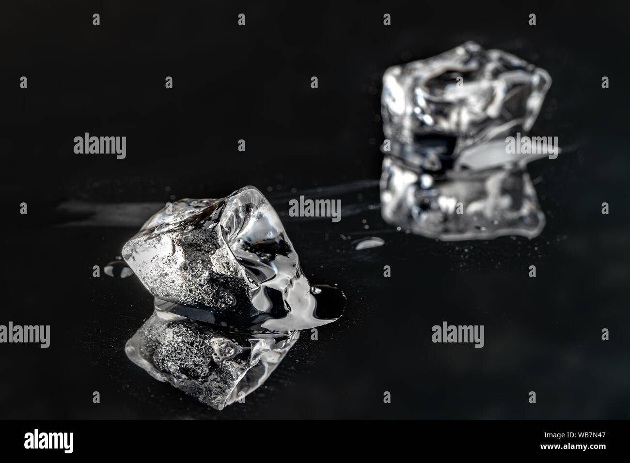 melting ice cubes on black background. close up Stock Photo