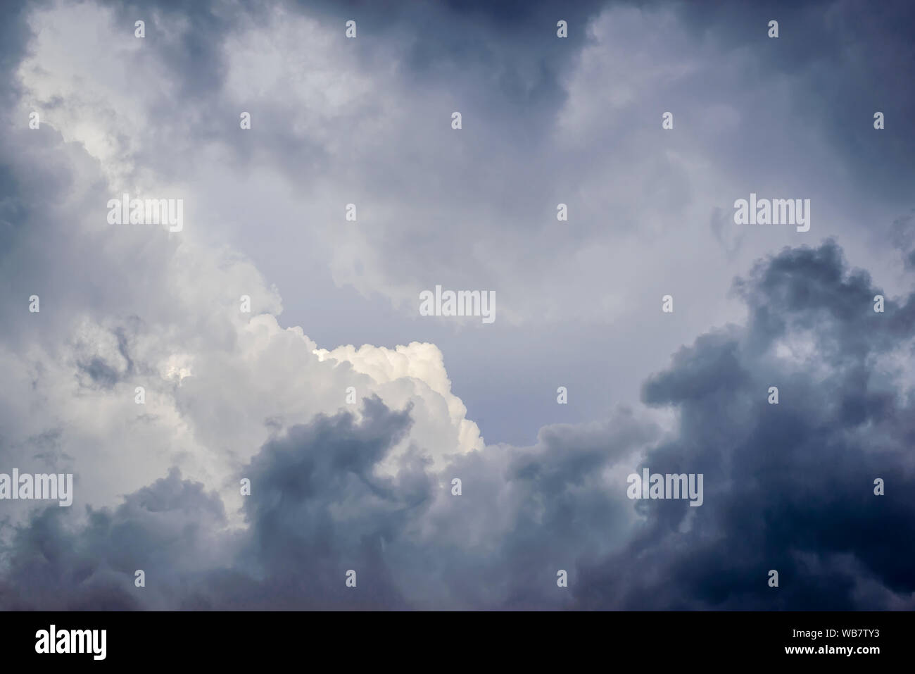Cloudy sky with dark gray storm clouds and light in the middle Stock ...