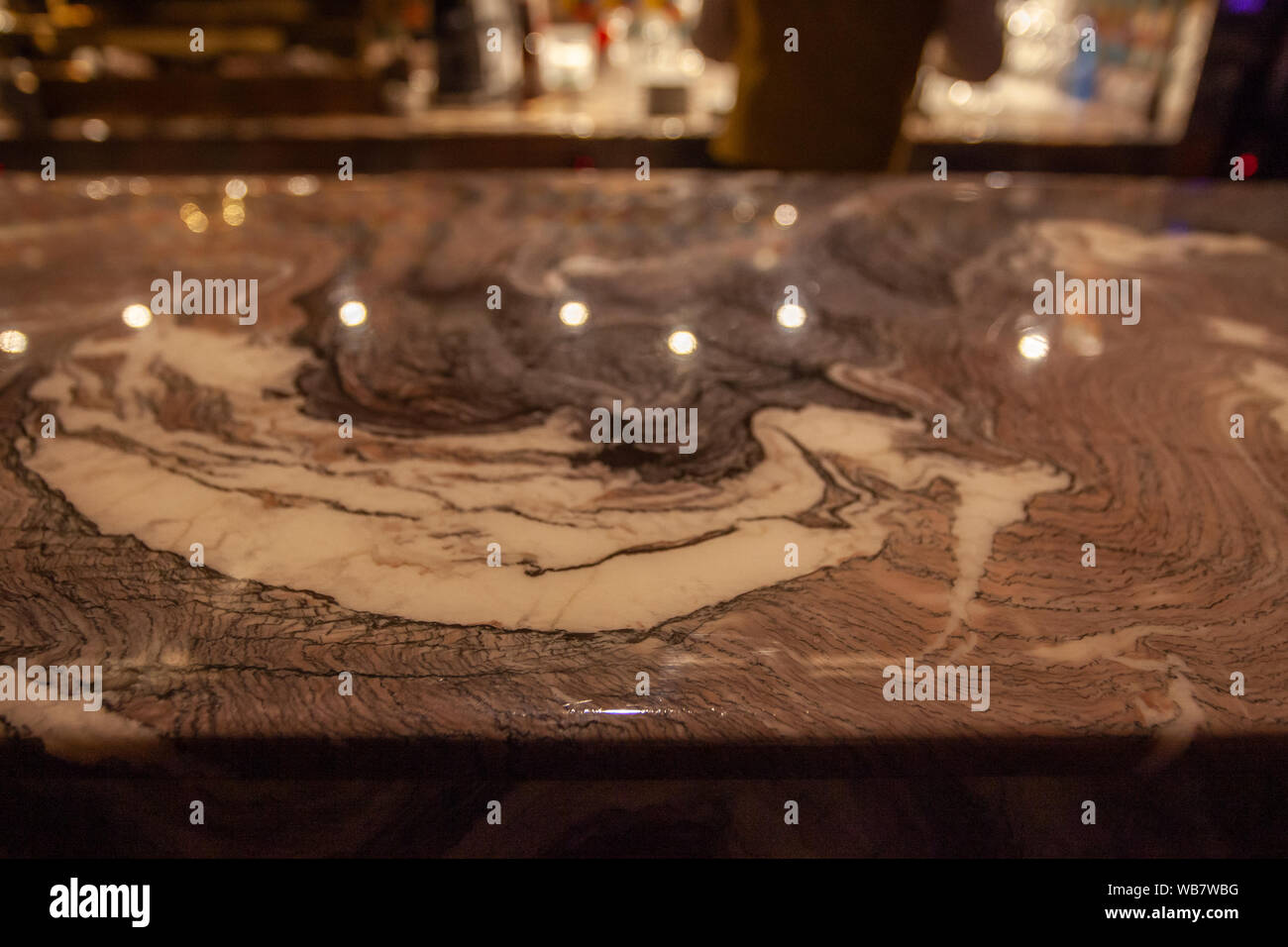 Bar counter detail made of gold-colored marble Stock Photo