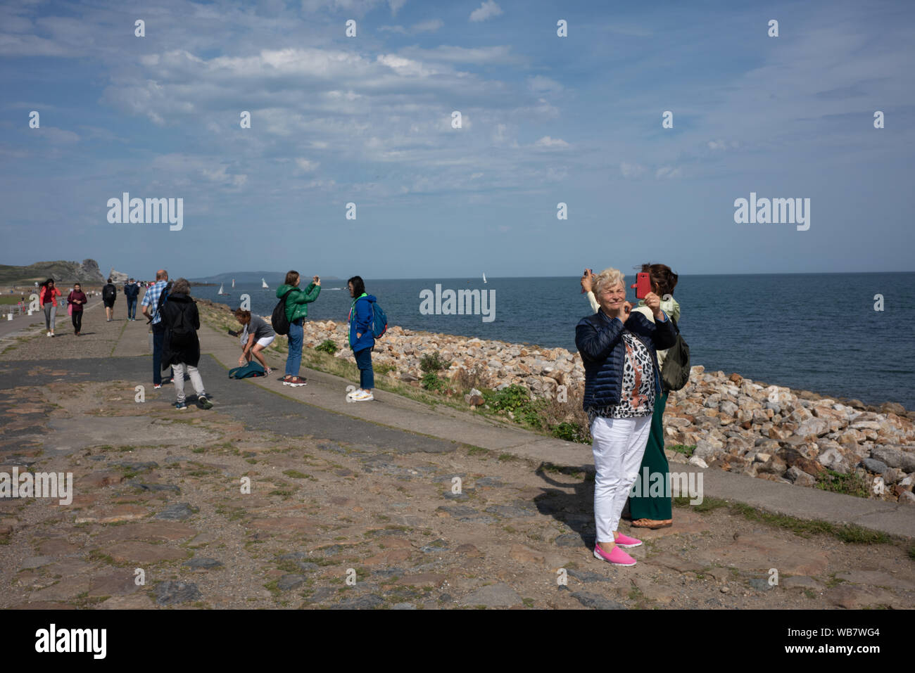 People taking photos on Howth pier, Dublin city, Ireland. Stock Photo