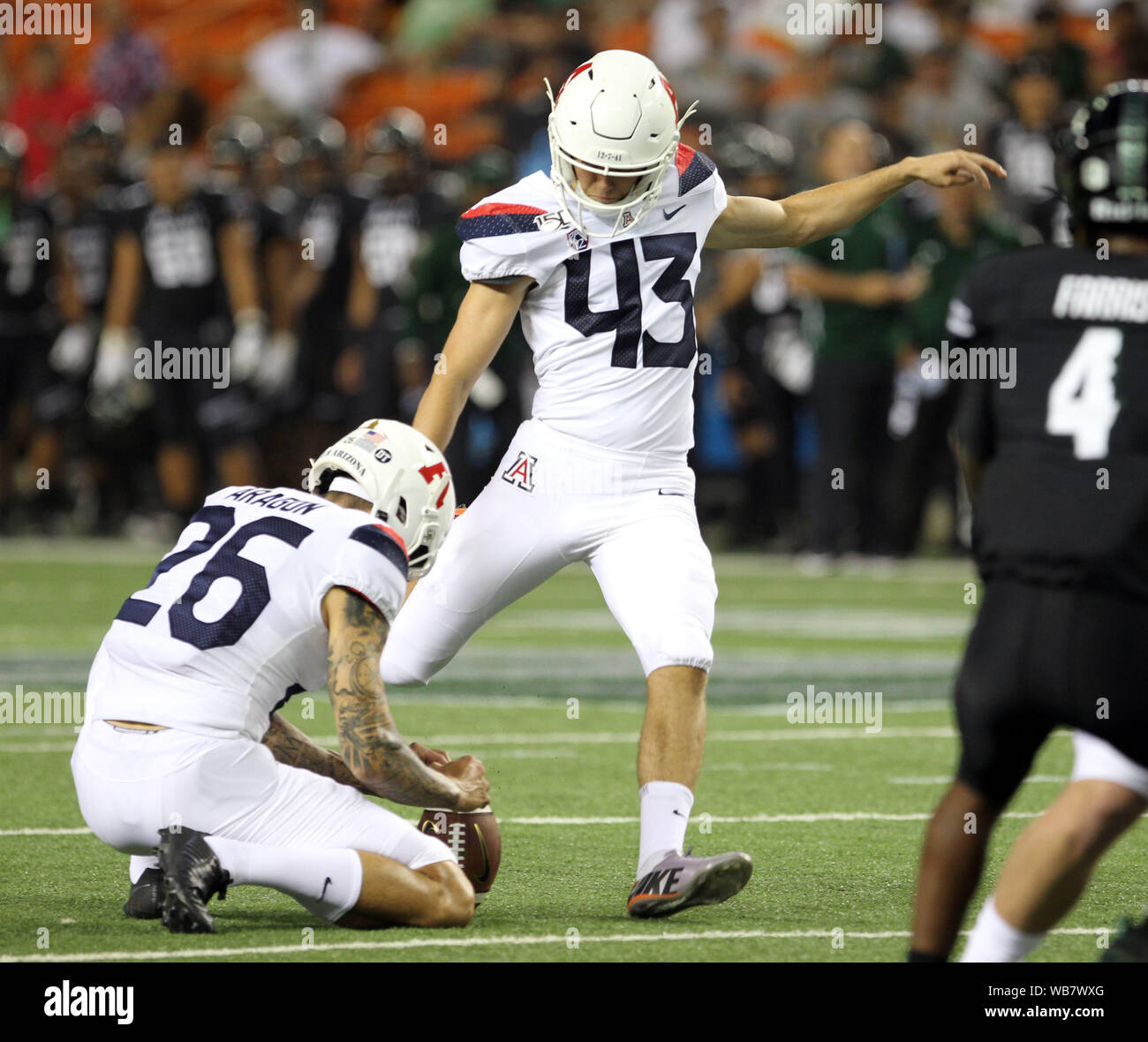 Honolulu, Hawaii, USA. 24th August, 2019. Basel, Switzerland. 25th Aug,  2019. AArizona Wildcats place kicker Lucas Havrisik #43 kicks an extra  point off the hold of Arizona Wildcats safety Samari Springs #29