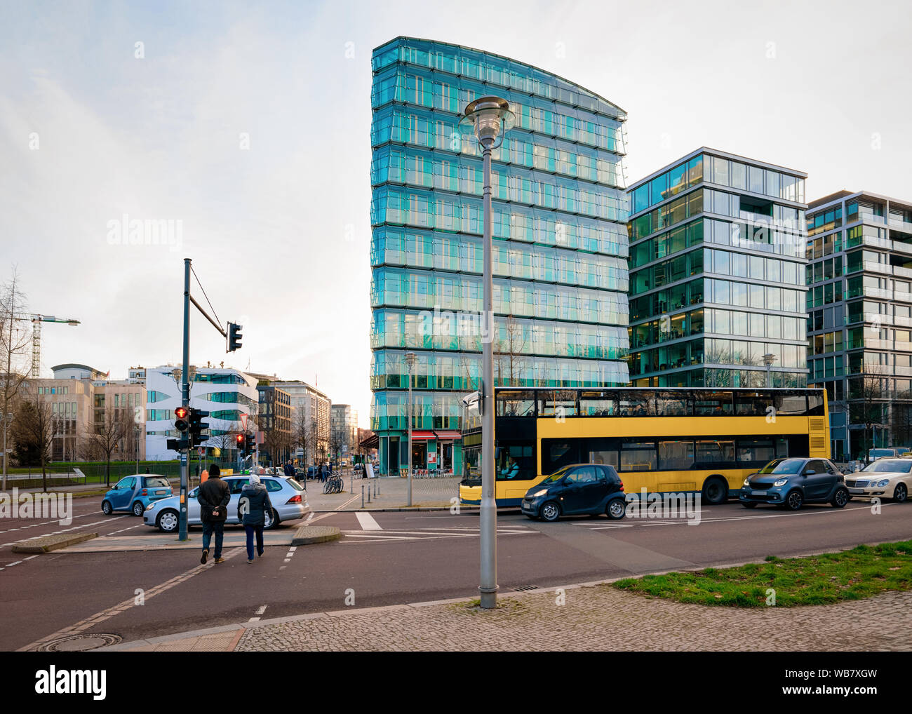 Arc In Berlin Street with bus and car traffic and modern building architecture in ...