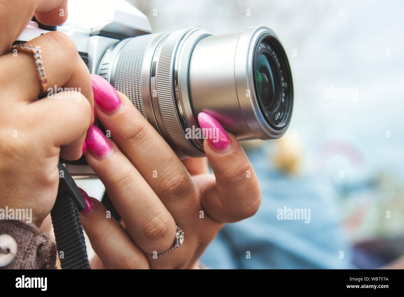 Close-up of a digital camera being used by a woman with painted fingernails Stock Photo