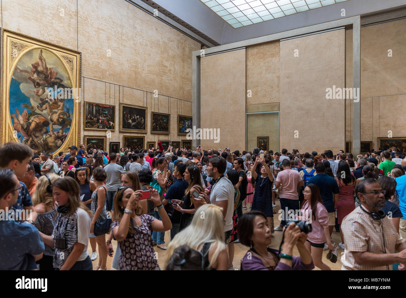 Paris, France - July 6, 2018: Mona Lisa at the Louvre Museum. Tourists photographing the famous picture of Gioconda in Louvre Museum. Leonardo DaVinci Stock Photo