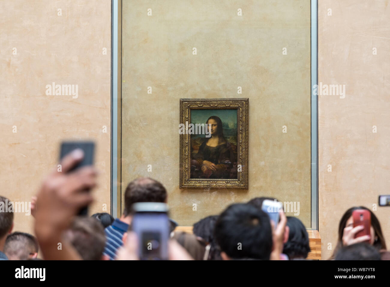 Paris, France - July 6, 2018: Mona Lisa at the Louvre Museum. Tourists photographing the famous picture of Gioconda in Louvre Museum. Leonardo DaVinci Stock Photo