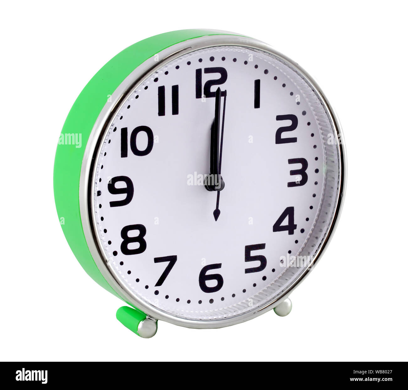 Green alarm clock isolated on white background. The hands are at twelve o'clock. Stock Photo
