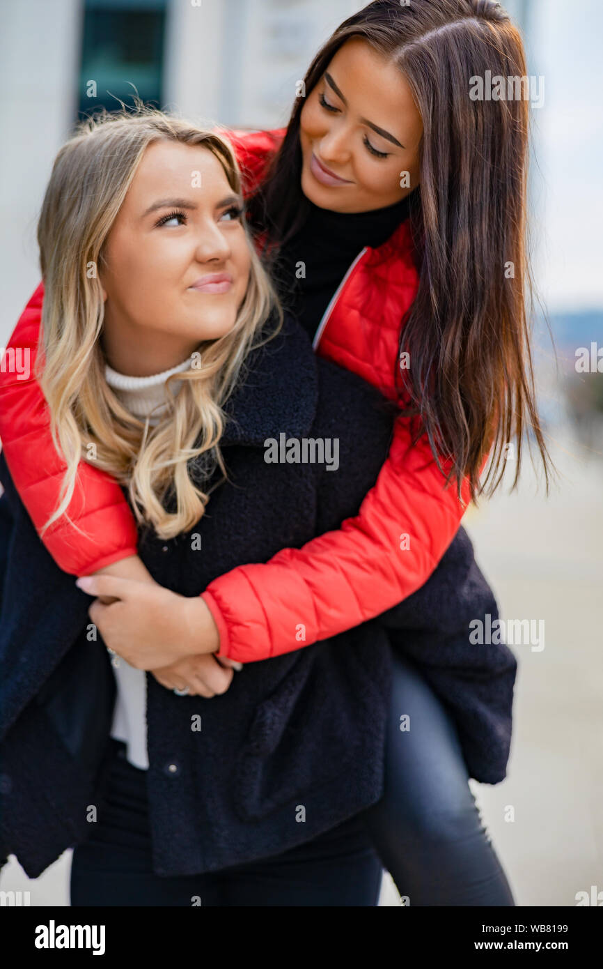 Close-up of Friend Having Fun and Piggybacking In City Stock Photo