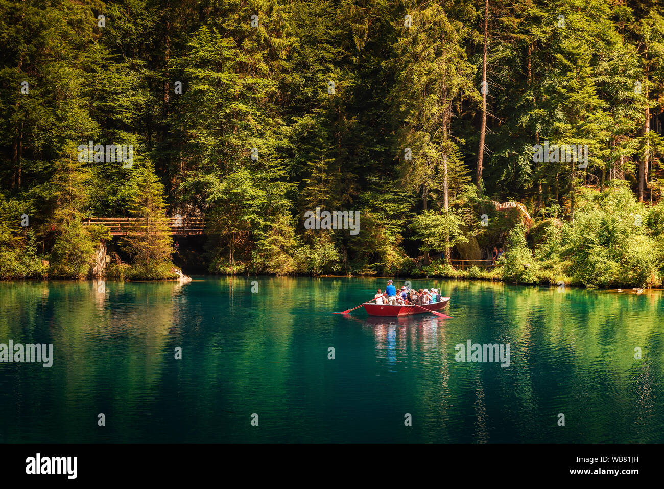 Tourists taking a boat trip on Blausee Lake in Switzerland Stock Photo