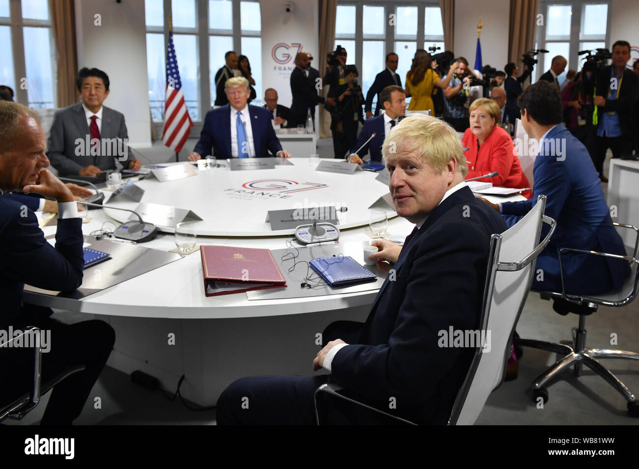 Prime Minister Boris Johnson looks on as Canada's Prime Minister Justin Trudeau, Germany's Chancellor Angela Merkel, European Council President Donald Tusk, France's President Emmanuel Macron, Italy's Prime Minister Giuseppe Conte, Japan's Prime Minister Shinzo Abe and US President Donald Trump meet for the first working session of the G7 summit in Biarritz, France. Stock Photo