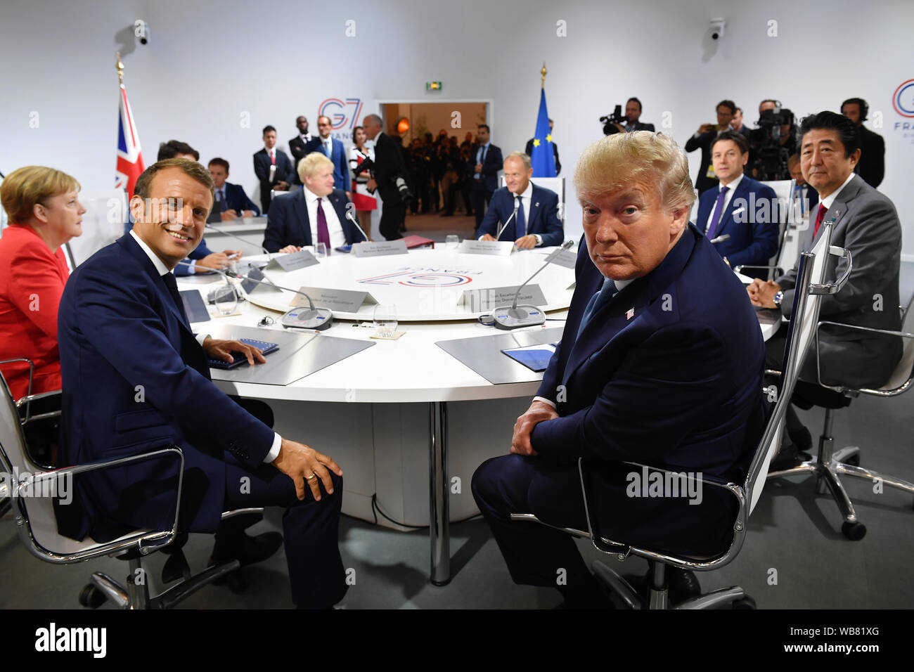 France's President Emmanuel Macron and US President Donald Trump pose for the media as they meet for the first working session of the G7 Summit in Biarritz, France. Stock Photo