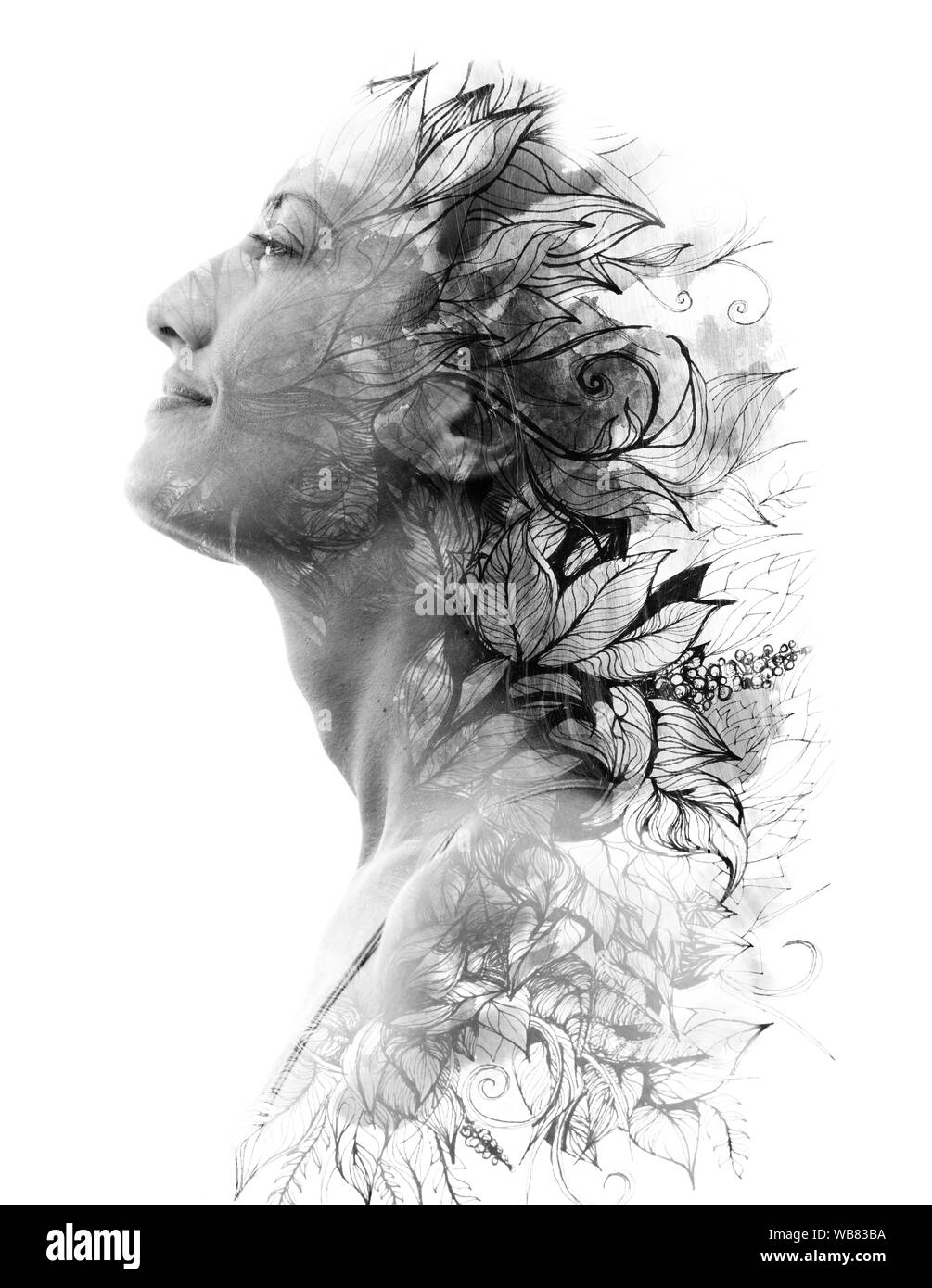 Double exposure. Paintography. Portrait of a beautiful young female model disappearing behind black ink painting on white background Stock Photo