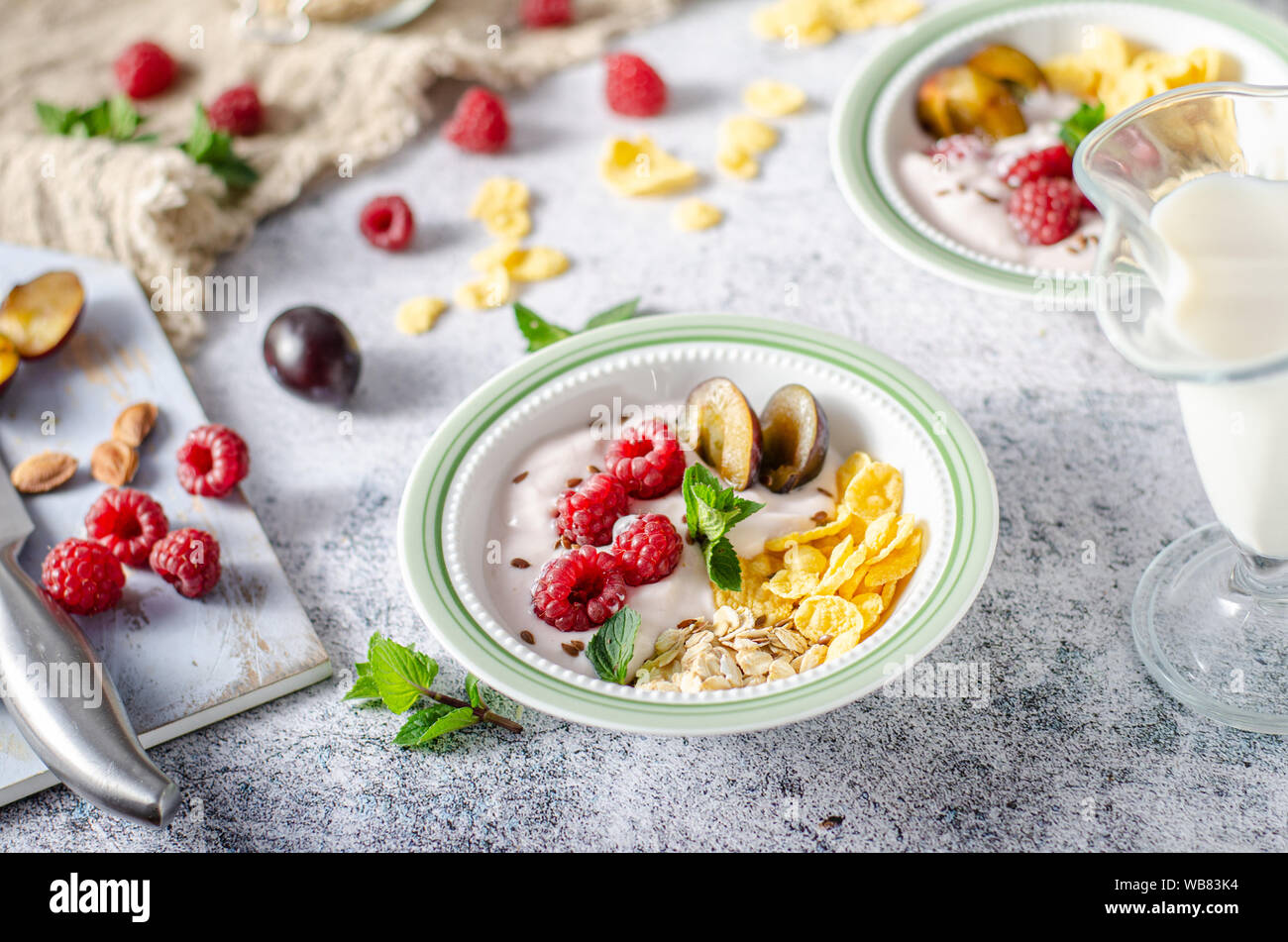 Full breakfast with lots of forest fruit, plums and yoghurt Stock Photo
