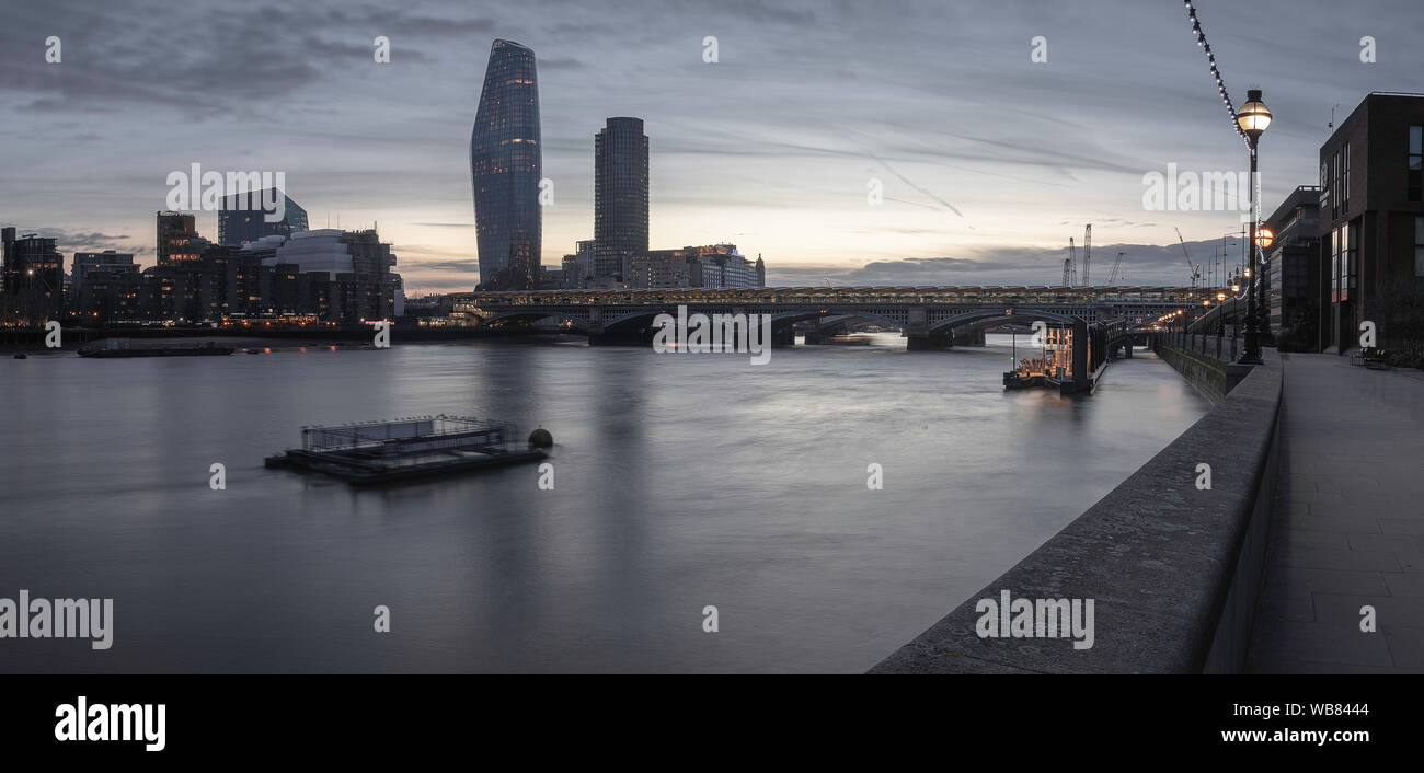 Evening in London near the riverside. Thames river and cityscape. Tate Modern and Millennium bridge. Stock Photo