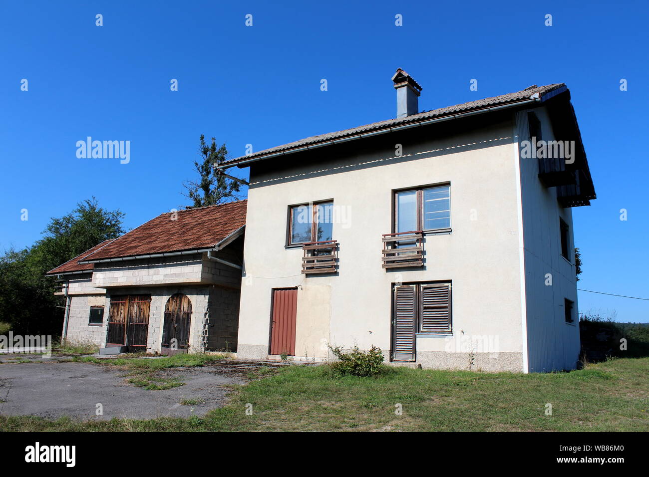 Abandoned Family House With Attached Garage And Outdoor Storage