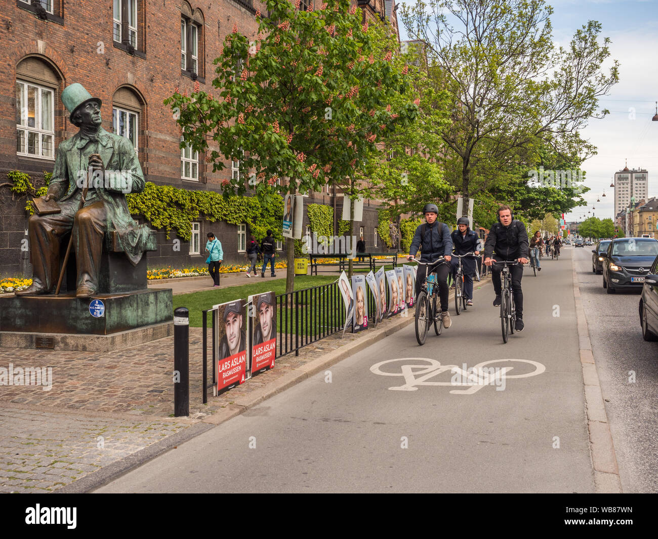 Copenhagen, Denmark - 1 May 2019 - Bronze statue of Hans Christian Andersen  by sculptor Henry Luckow-Nielsen next to City Hall and bicycle path  in K Stock Photo