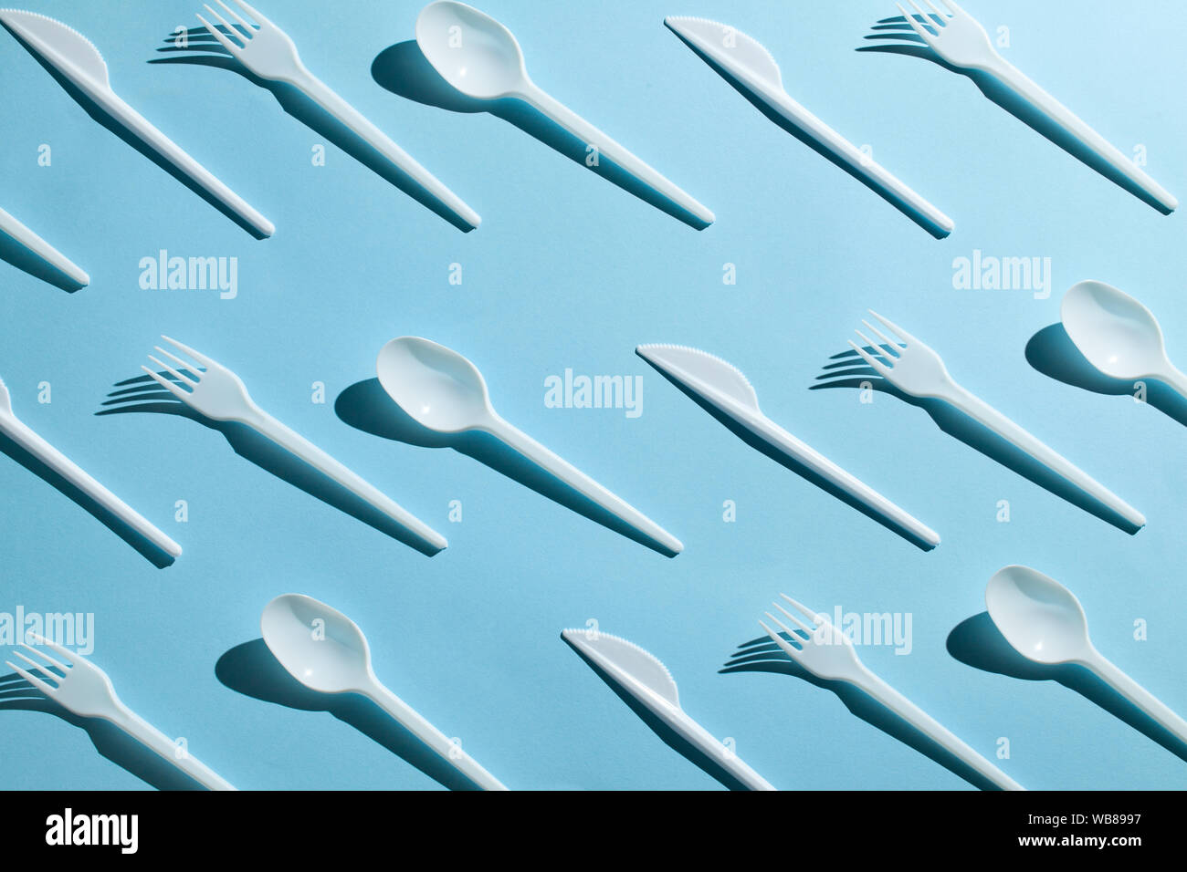 Plastic cutlery, forks, spoons and knives. Pollution of the environment with plastic and