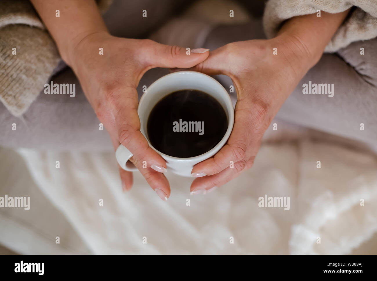 Women hands holding cup with hot coffee Stock Photo