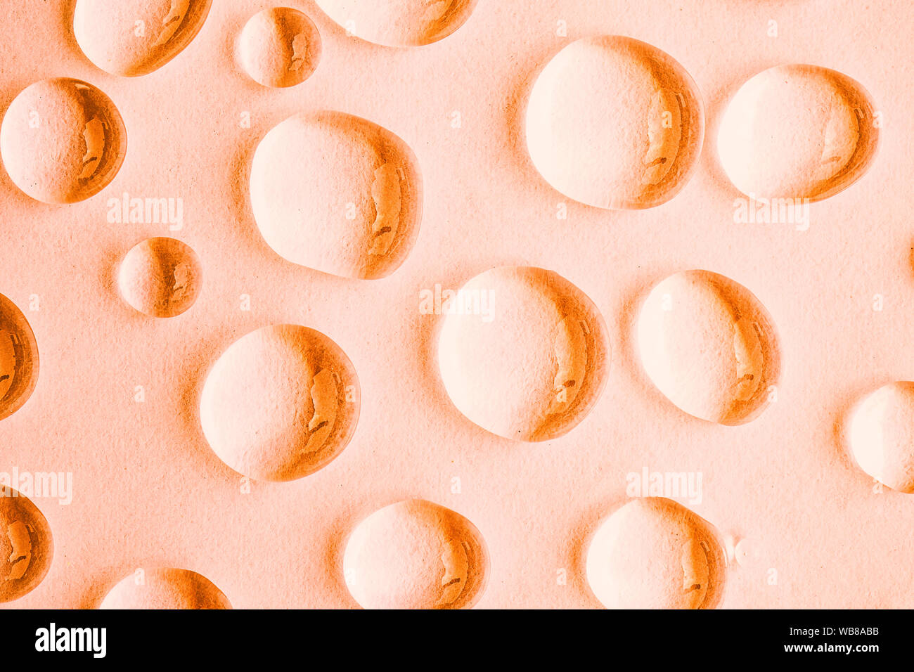 Water drops on orange abstract background, top view Stock Photo