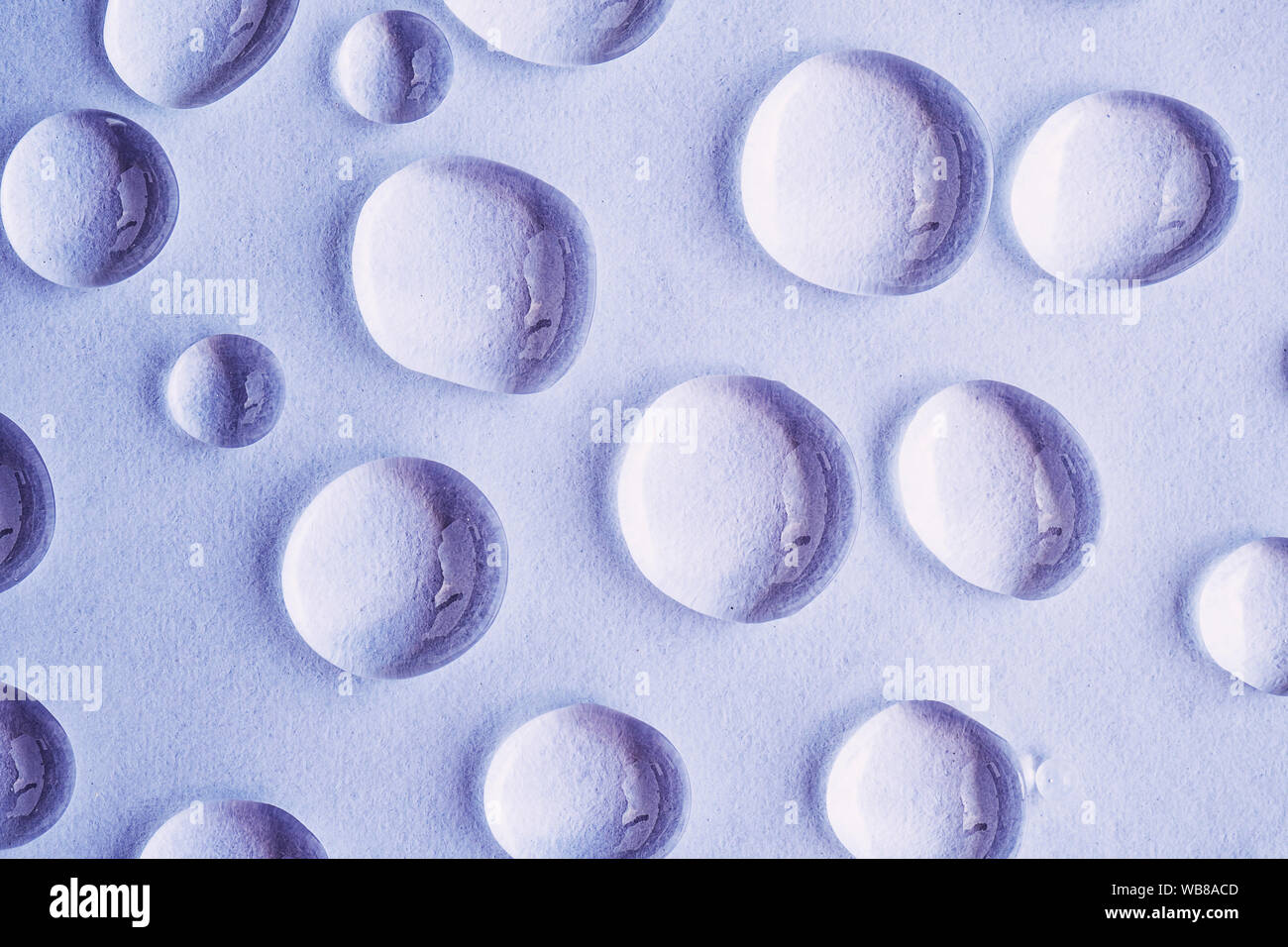 Water drops on purple abstract background, top view Stock Photo