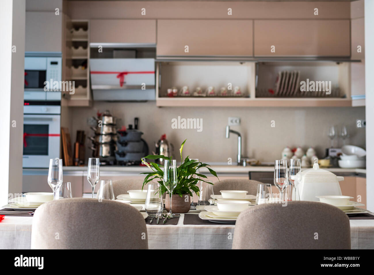Modern gray kitchen with table set Stock Photo - Alamy